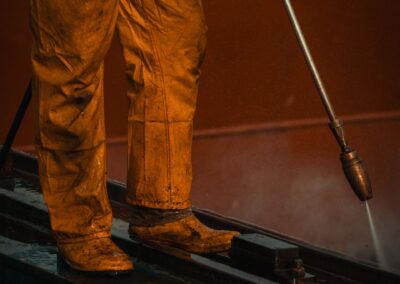 Pressure washing in action — operator with professional equipment