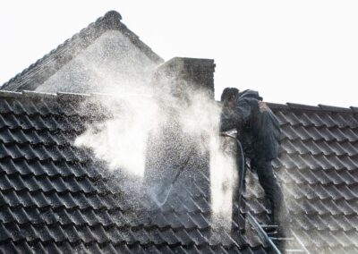 Roof cleaning — power washing roof tiles to remove grime